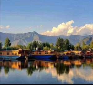 a group of boats sitting in the water at Houseboat young Minar in Srinagar