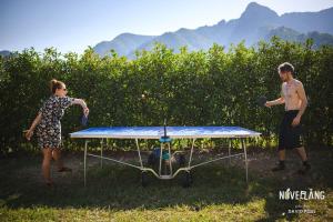 a man and a woman playing ping pong on a table at Ecoglamping Tramonti in Tramonti