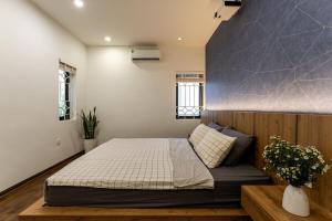 a bedroom with a large bed in a room at HanoianHearths - FamilyReunion- Projector- Bathtub in Hanoi +26 photos