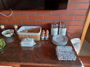 a counter with plates and utensils on a table at Möwennest Zempin in Zempin +24 photos