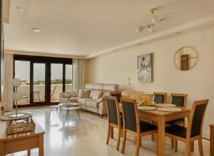 a living room with a table and a couch at Green Haven Casares in Casares