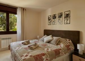 a bedroom with a bed with two stuffed animals on it at Green Haven Casares in Casares +20 photos