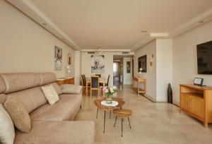 a living room with a couch and a table at Green Haven Casares in Casares