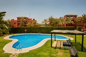 a swimming pool in the middle of a yard at Green Haven Casares in Casares