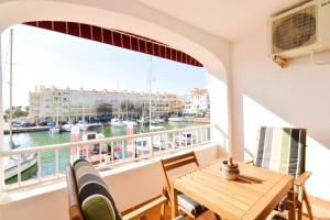a balcony with a table and chairs and a view of a harbor at Expoholidays - Centro Almerimar Puerto Deportivo in Almerimar