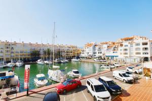 a group of cars parked next to a marina with boats at Expoholidays - Centro Almerimar Puerto Deportivo in Almerimar
