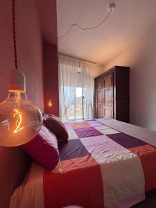 a bedroom with a large bed with a large window at Vista con camera - appartamento Grignolino in Casale Monferrato
