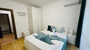 a bedroom with a bed with two stuffed animals on it at ASTORIA II Apartment 12 Sveti Vlas in Elenite +36 photos