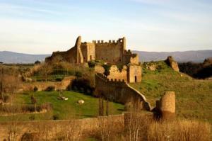 an old castle sitting on top of a hill at La Casa di Gioia in Tuscania
