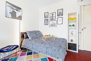 a bedroom with a bed and a table on a rug at Hyper Center - Air conditioning - Balcony - Wifi - Tramway - Quiet in Nice
