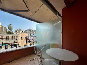 Zimmer mit einem Tisch und einem Kühlschrank auf dem Balkon in der Unterkunft La Bouganville 2 in Arma di Taggia