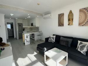 a living room with a couch and a table at Toni LuXx Suite Monte Golf in Mogán