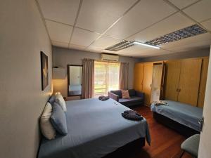 a hotel room with a bed and a couch at Stay at 126 in Bloemfontein +71 photos