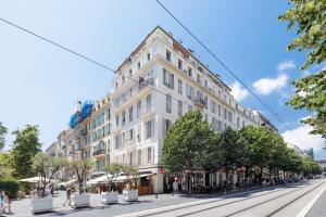 a large white building on a city street at Hyper Center - Air conditioning - Balcony - Wifi - Tramway - Quiet in Nice