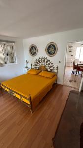 a bedroom with a large yellow bed in a room at villa petar apartment a4 with terrace in Ivan Dolac