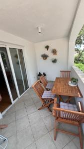a patio with a wooden table and two chairs at villa petar apartment a4 with terrace in Ivan Dolac