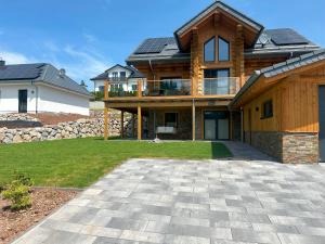 a house with solar panels on top of it at Ferienwohnung Uplandblockhaus in Willingen