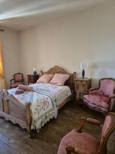 a bedroom with two beds and a table and two chairs at Chez Mamie Gramat centre in Gramat +26 photos