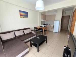 a living room with a couch and a table at Perfect Apartment in Nea Potidaea