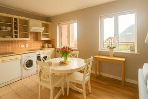 a kitchen with a table and chairs in a kitchen at Youghal in Youghal