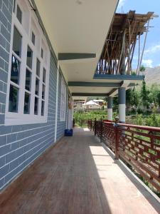 a porch of a building with a wooden walkway at stargazing homestay Nako in Nako