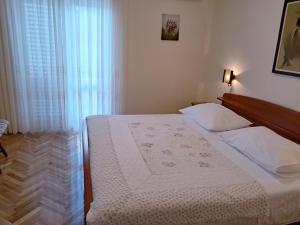 Postel nebo postele na pokoji v ubytování Apartments Melinda