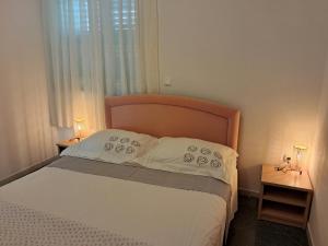 Postel nebo postele na pokoji v ubytování Apartments Melinda