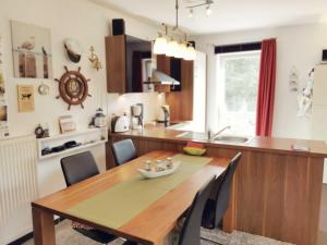 a kitchen with a wooden table and a dining room at Ferienwohnung Granata 52 0S in Schillig