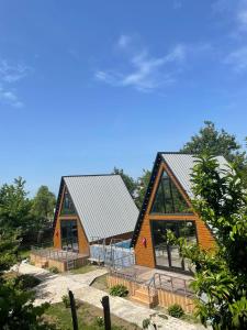 two large wooden homes with metal roofs at ტყუპები in Kobuleti