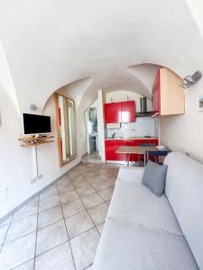 a living room with a couch and a kitchen at La casa di Patrick in Riva Ligure