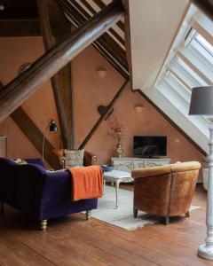 a living room with two couches and a table at Apartment Noorderloft in Hornhuizen