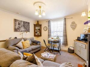 a living room with a couch and a table at 2 Bed in Robin Hoods Bay 87059 in Robin Hood's Bay