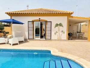 a villa with a swimming pool and a house at Casa del Sol with private pool in Mazarrón