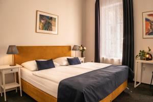 Postel nebo postele na pokoji v ubytování BlueBell Hotel