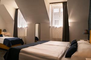 Postel nebo postele na pokoji v ubytování BlueBell Hotel