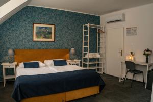 Postel nebo postele na pokoji v ubytování BlueBell Hotel