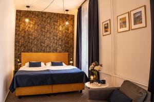 Postel nebo postele na pokoji v ubytování BlueBell Hotel