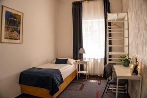Postel nebo postele na pokoji v ubytování BlueBell Hotel