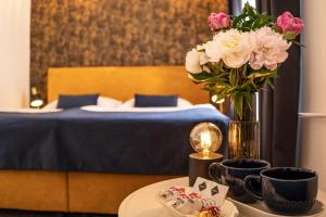 Postel nebo postele na pokoji v ubytování BlueBell Hotel