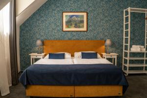 Postel nebo postele na pokoji v ubytování BlueBell Hotel