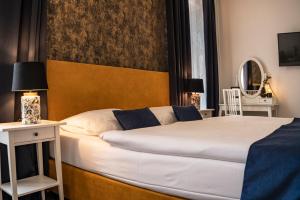 Postel nebo postele na pokoji v ubytování BlueBell Hotel