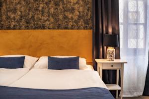 Postel nebo postele na pokoji v ubytování BlueBell Hotel