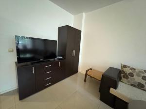 a living room with a flat screen tv and a couch at VP Palazzo Nesebar in Nesebar