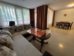 a living room with a couch and a table at VP Palazzo Nesebar in Nesebar