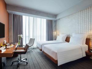 Voodi või voodid majutusasutuse Pullman Jakarta Central Park toas