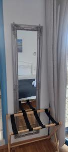 a mirror sitting on a stand in a room at Kalliopis Rooms in Katapola