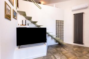 a living room with a flat screen tv on a wall at Ibis Lodge With Swimming Pool in Palermo