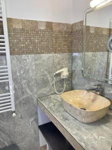 a bathroom with a wooden sink on a counter at Casa Miru in Mangalia