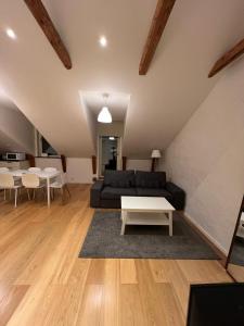 a living room with a black couch and a table at Home Inn Rör11 in Stockholm