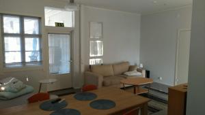 a living room with a couch and a table at Valkoinen Talo B in Koura